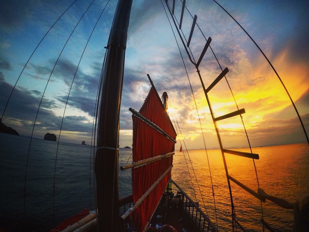 Krabi Morning Cruise sunrise view from between boat sails