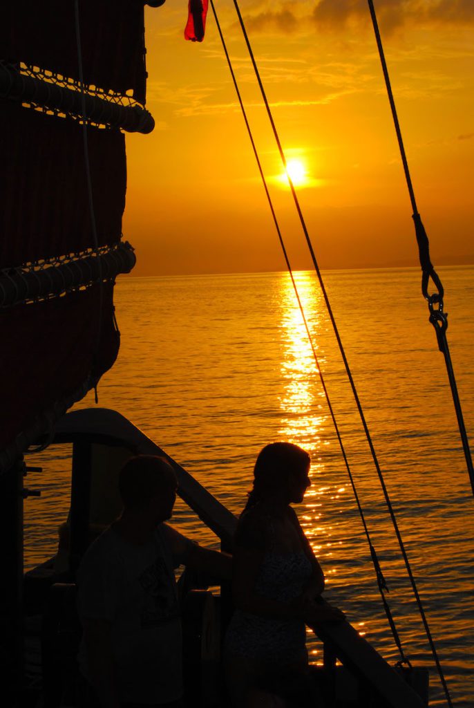 Silhouette of guest on Krabi Sunset Cruise as sun is setting in the background