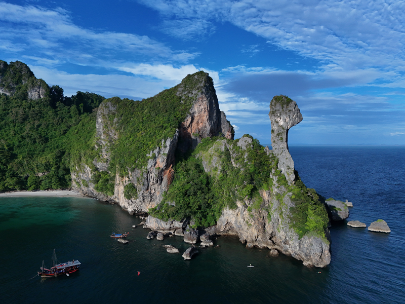 Aerial view of Chicken Island with its iconic rock formation and lush cliffs rising over the Andaman Sea.