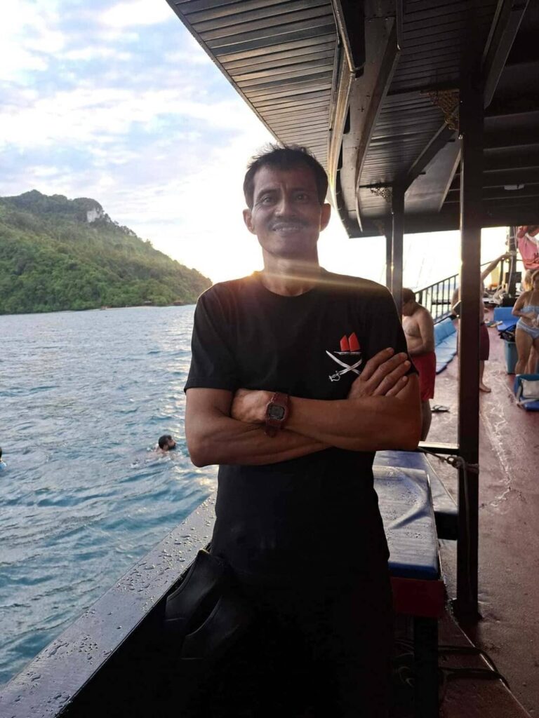 Gun, Krabi Sunset Cruises barman and deckhand, standing aboard the boat